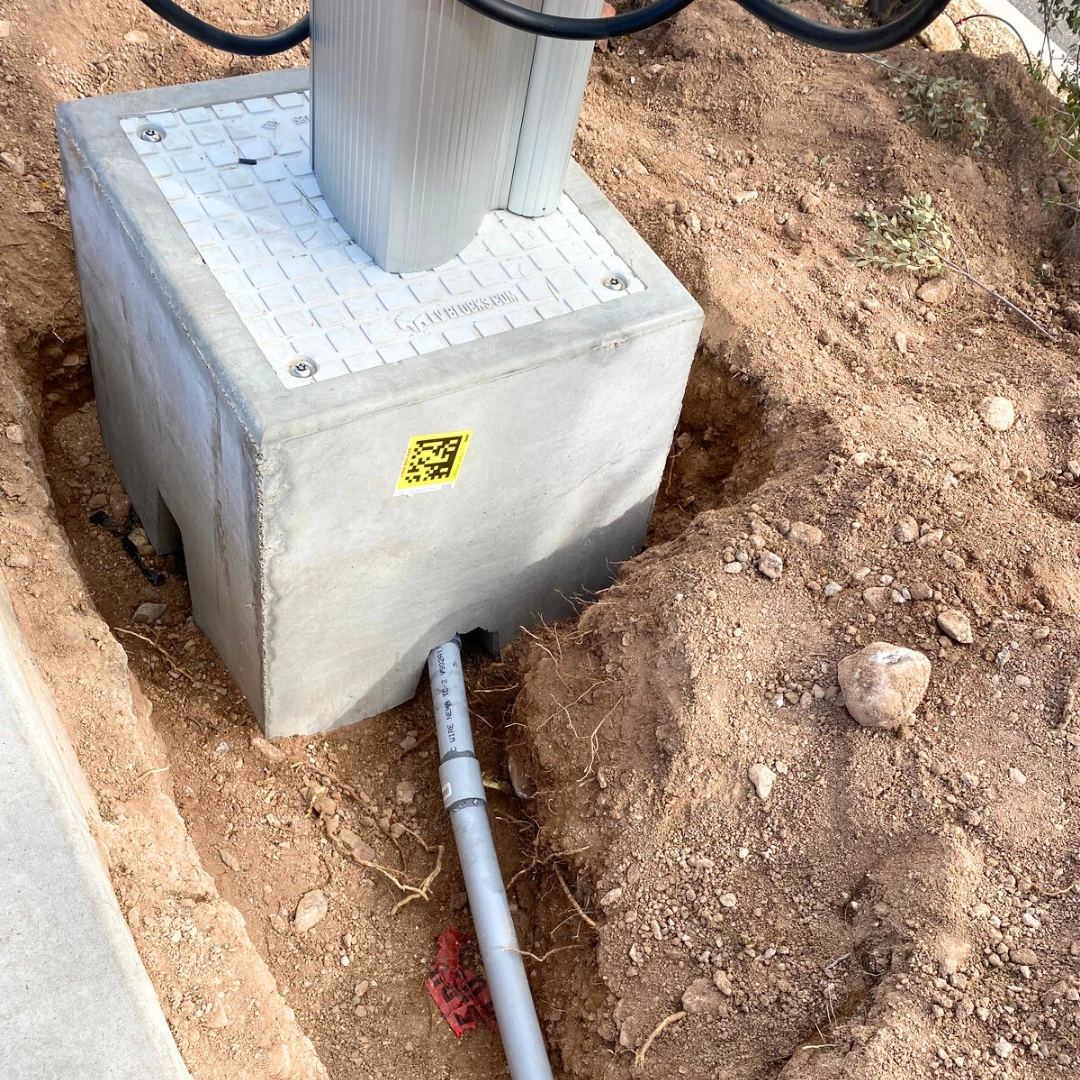 Cabling being set up through the Standard EV Block foundation base for, full EV charger installation.